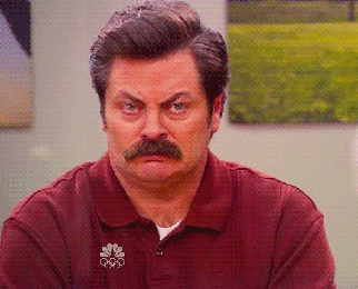 a gif of ron swanson from parks and recreation looking unimpressed